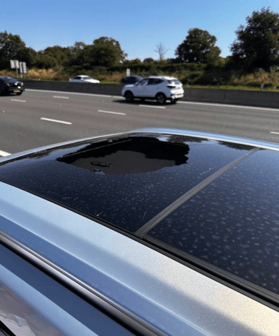 Large bullseye crack and stone chip on sunroof before FixGlass replacement